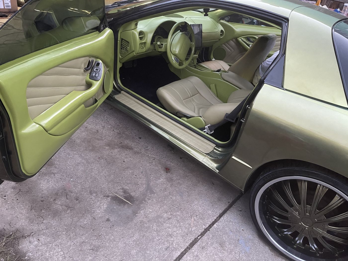Green coupe with a light gray interior