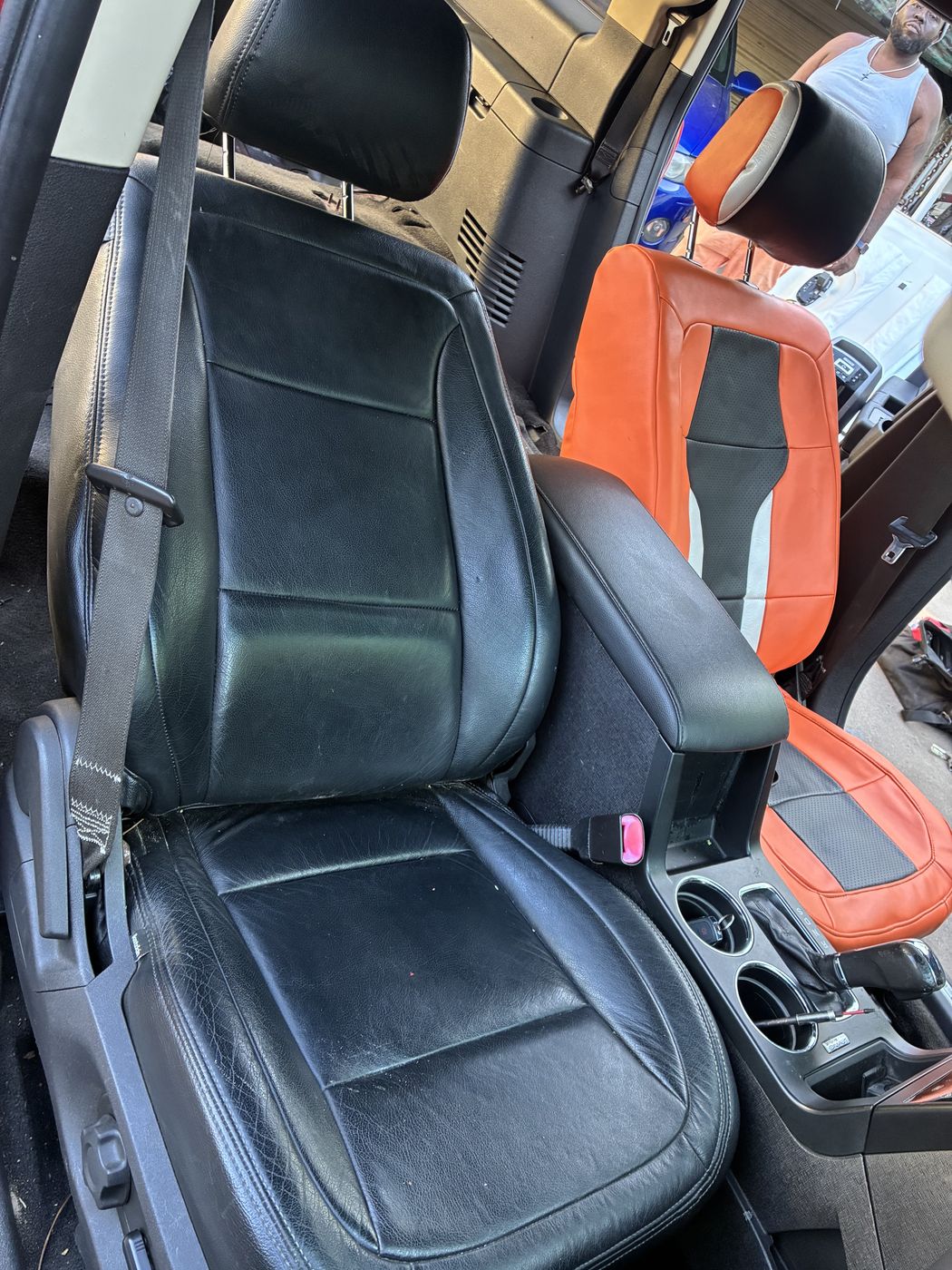 Black leather seat with orange accents