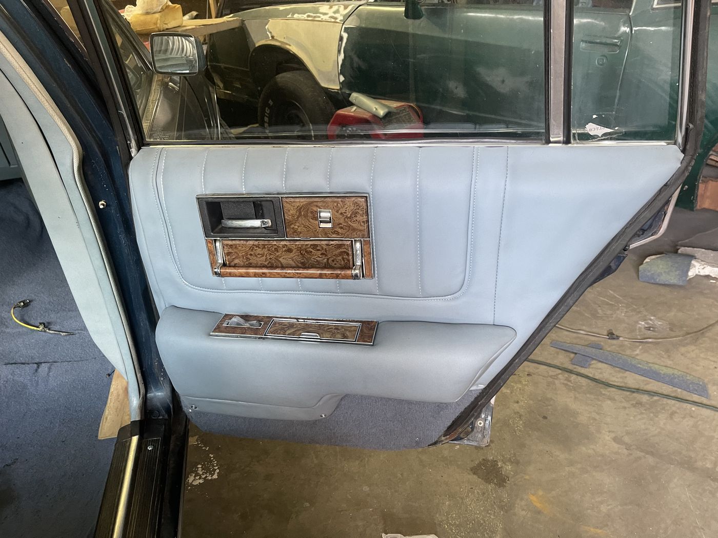 Light gray door panel with woodgrain trim