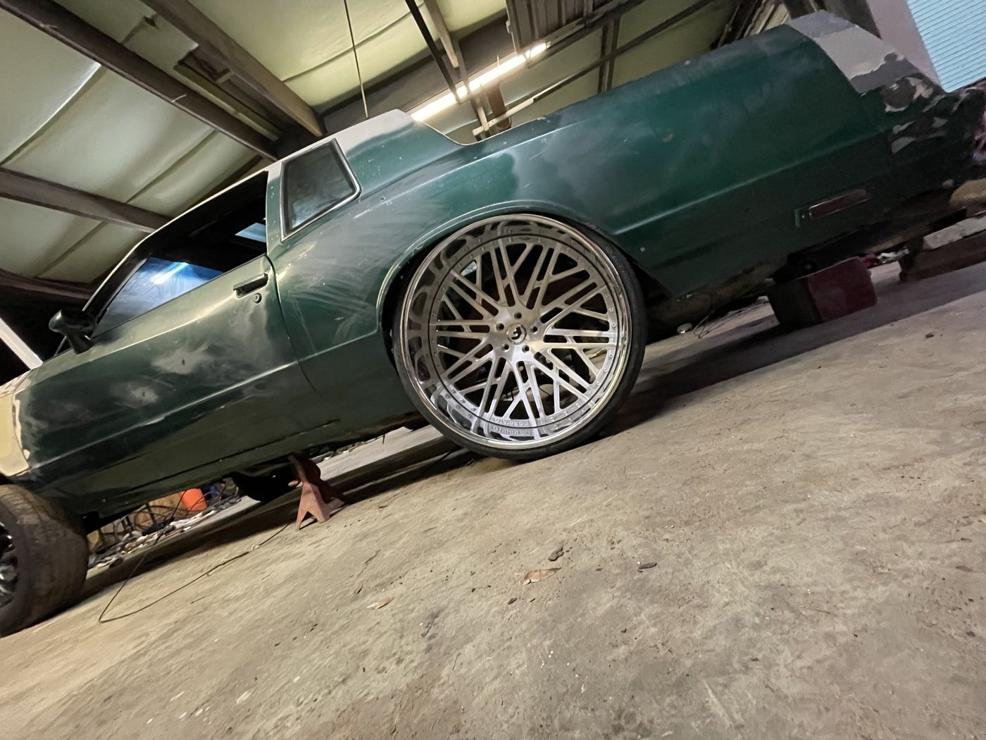 Green classic car on custom wheels