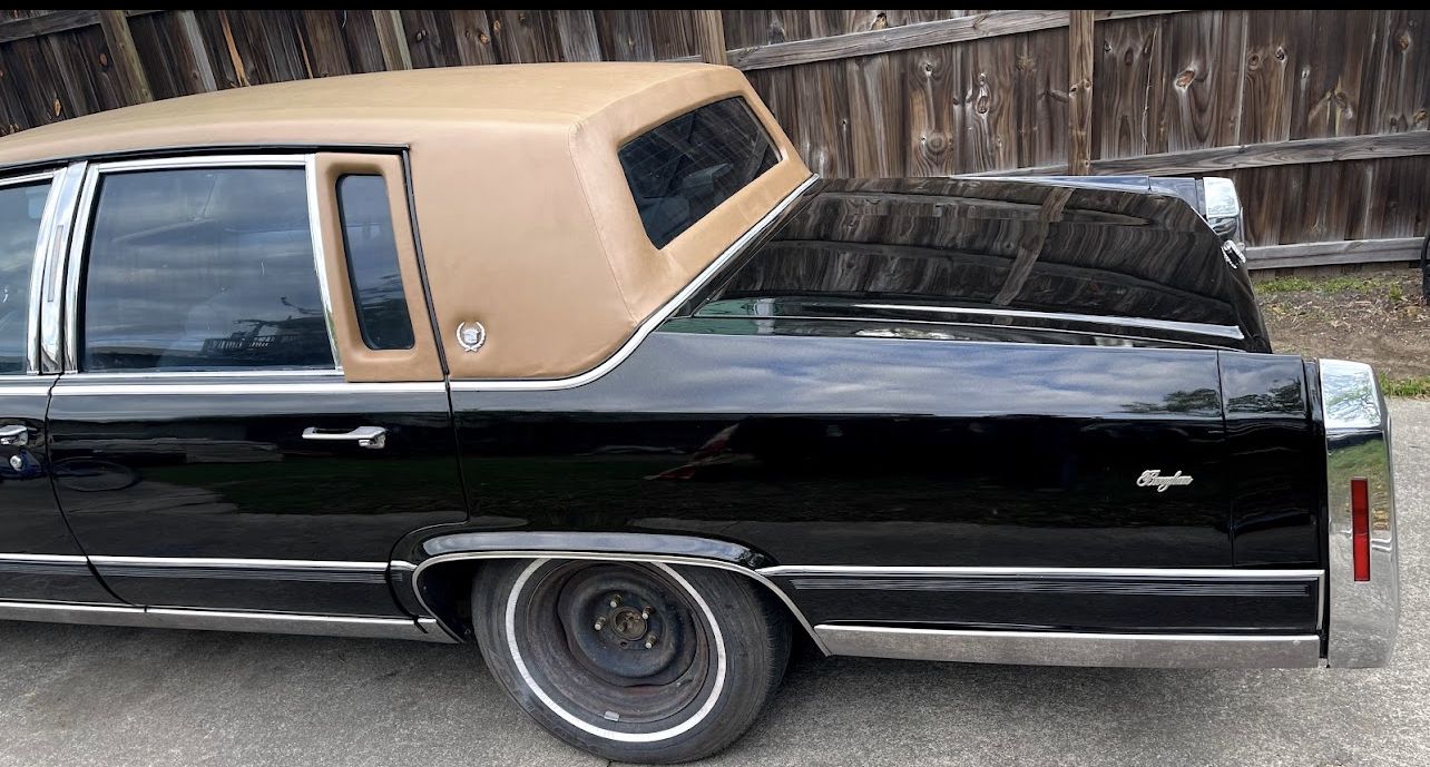 Black Cadillac with a tan landau top