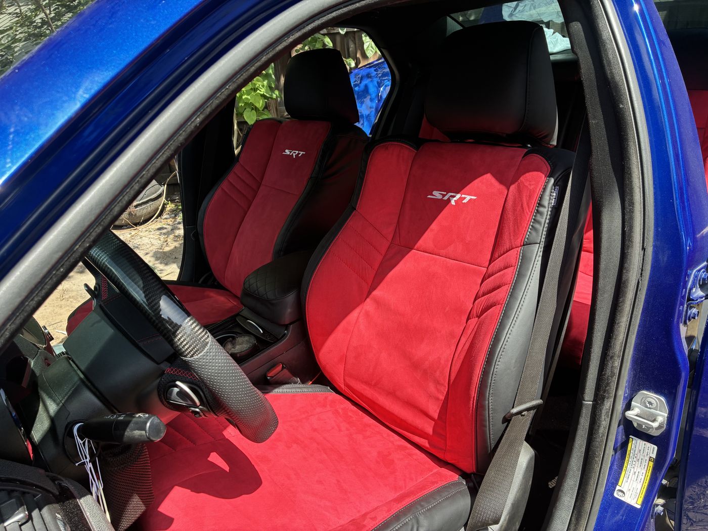 Red and black seats in a blue Dodge