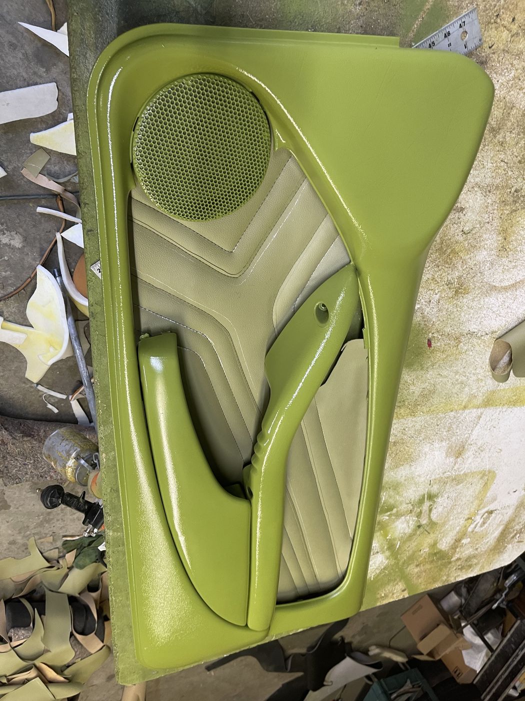Green door panel with a stitched pattern