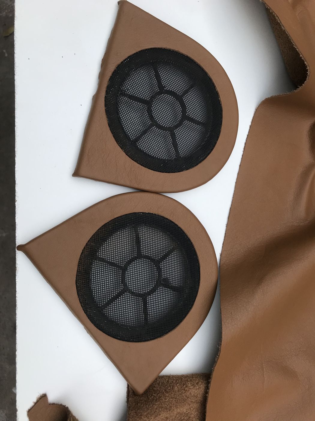 Speaker pods covered in tan leather